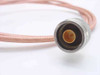 Times Fiber RG-142/U N-male connector close-up showing gold center pin and knurled stainless coupling nut