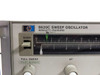 HP 8620C Sweep Oscillator rear panel showing BNC connectors, GPIB interface port, and cooling fan — three-quarter rear view