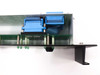 Varian VJW6703AR00 interior top view – showing two blue ribbon-cable D-sub connectors mounted to chassis and green PCB assembly with solder points