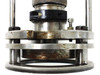 Logitech PM2A ring polishing jig head – alternate front three-quarter view showing rust on base plate and vertical guide rods