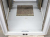 Rackmount cabinet floor view showing cable entry knockout plate and two built-in power outlets at base