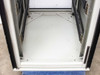 Varian VZC6967R4 cabinet floor interior – painted steel floor with open bi-fold door hinges and caster base visible