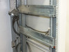 Xicom Technology rack cabinet — close-up of lower internal rack rail section showing HD-50 multi-pin cable bundle routed through chassis
