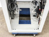 Xicom Technology rack cabinet — bottom interior view showing floor cut-out with blue anti-static mat panel, castors visible below chassis