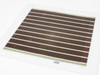 Konarka Power Plastic Model 110 flexible solar cell — back side straight-on view showing brown horizontal stripes with white separators and flexible laminate construction