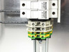 Close-up of Ferraz Shawmut ULTRASAFE 690V 32A breaker holders and green-yellow grounding terminal blocks on DIN rail