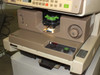 3M 7540MFB AJ close-up of film cartridge loading area with green cartridge carrier, illuminated stage, and front control panel