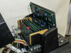 Sorvall RC-80 electronics card cage tilted open revealing multi-board stack with green PCBs, blue capacitors, and ribbon cable connections