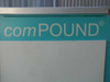 Close-up of comPOUND registered trademark branding on teal freezer cabinet panel