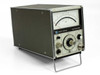 HP Hewlett-Packard 435B Analog Power Meter — three-quarter front-left view showing analog meter face, ZERO and RANGE controls, CAL FACTORS switches, and POWER REF output on olive-gray benchtop chassis with fold-out front leg