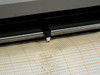 Graphtec WR3320 thermal stylus close-up — heated pen tip resting on orange-grid chart paper