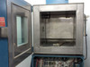 Thermotron SM-16-SL chamber interior close-up with door open, stainless steel inner chamber walls and perforated ceiling diffuser plate visible