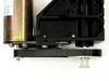 Underside view of Pittman motor and black aluminum gear frame showing dual gear shafts, belt, and motor body with surface patina