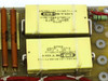 CPI Satcom Gen IV HV Module 01026320 – macro closeup of two Custom KMR1A6607SP-2 yellow HV capacitors rated 0.1uF 6000V DC, part number E97S2-01014671-2