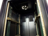 Interior top view of the rackmount cabinet showing the installed cooling fan centered at the top and rear ventilation louvers