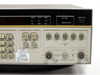 HP 3325A right-side front panel showing FUNCTION selector buttons, SIGNAL and AUX outputs, SYNC OUT, and calibration label