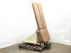 Tri W-G 645 chiropractic tilt table shown fully tilted upright at approximately 90 degrees, side view, tan upholstery and cream steel frame on pallet