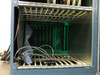 Hughes WD-8702-001 card cage – lower slot row mostly empty; multi-pin cable and connector visible at front; green backplane illuminated