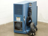 Hughes WD-8702-001 wire bonder control cabinet – rear-left view showing ventilation panel, caution label, large cooling fan, and power cable with twist-lock plug