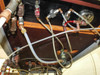 Underside of table showing additional plumbing with brass pressure regulator, valves, and tubing manifold