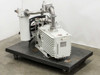 Leybold D60AC TRIVAC vacuum pump on wheeled dolly, front-right view showing TRIVAC badge on pump body and oil filter/mist separator canister on left with stainless piping and NW clamp fittings