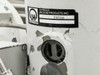 Leybold Vacuum Products label and oil drain port with black cap; paint chipping and peeling visible on pump body around port area