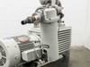 Close-up of oil filter/mist separator canister and vacuum inlet piping with NW clamp fittings and stainless elbow, motor in background
