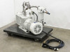 Leybold D60AC TRIVAC rotary vane vacuum pump with GE motor on wheeled dolly, front-left view, power cable coiled in foreground and mist separator canister visible at top right