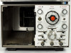 HP 1821A Time Base and Delay Generator front panel close-up showing TIME/CM dial, RESET button, orange RESET indicator light illuminated, SWEEP MODE and SLOPE controls