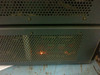 Side panel of HP 180A Oscilloscope showing orange indicator lights glowing through ventilation holes on the side of the chassis