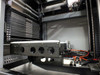 Close-up of single transport rail assembly with four circular openings, orange pneumatic lines, and actuator mechanism at the base of the magazine