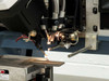 Hughes 2460 Wire Bonder – bonding head assembly close-up showing capillary/wedge tool, wire feed mechanism, and work stage