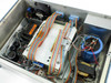 Syn-Optics AFS3000D – interior top-down view showing internal PCBs, ribbon cables, transformer, capacitor, and cooling fan