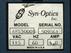 Syn-Optics AFS3000D rating plate showing Model AFS3000D, Serial No. 509D61, 115VAC, 60Hz, 4.0 Amp, Made in U.S.A.