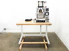 Custom heated pneumatic press on white-painted steel work table with wooden top – full front-right view