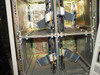 Digital SA600-xA interior view with front panels open — four empty DASD drive bays showing ribbon cable assemblies and backplane wiring, HDDs removed