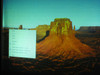 Avio MP-300E — projected test image showing color landscape photo with on-screen slideshow menu, confirming working display output