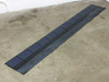 Uni-Solar SHR-17 amorphous flexible solar shingle laid flat on floor showing full 86-inch length and 12-inch width with blue PV cells
