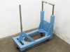 Blue steel rolled material handler dispenser cart – right front three-quarter view showing 1.25" stainless shaft, dual push handles, and swivel casters