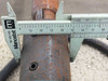 Caliper measurement of output shaft diameter showing surface rust on shaft – inch scale visible