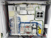 SCE hi-pot control cabinet interior lower panel close-up showing DIN rail terminal blocks, three-phase contactors, safety relay, and 4-outlet AC strip
