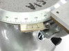 Close-up of the divided circle vernier scale on Griffin & George rotary measuring stage showing degree graduations 140–180 and vernier subinterval markings