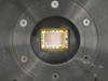 Close-up of Photometrics CH220 CCD image sensor chip mounted in circular black housing showing gold-wire bonded sensor die