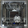 BFB 3000 Plus interior top-down view showing dual extruder print head assembly, XY gantry rails, stepper motors, and wiring harness
