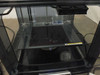 BFB 3000 Plus interior front view showing print bed surface with residue, bed leveling hardware, and enclosure interior