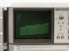 HP 8566B CRT display close-up showing active green phosphor spectrum trace, 100Hz–22GHz label visible on bezel