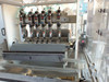 Close-up of Tidland pneumatic knife ring slitter station – six knife heads mounted over slitter roll