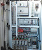 Allen-Bradley control cabinet interior – SLC PLC rack, PowerFlex VFDs, safety relays, and Schneider drive visible