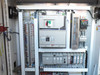 Allen-Bradley control cabinet upper section – PowerFlex drive, main breakers, PLC rack, and terminal strips