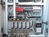 Allen-Bradley control cabinet lower section – multiple PowerFlex VFD drives, safety relay module, and wiring harnesses